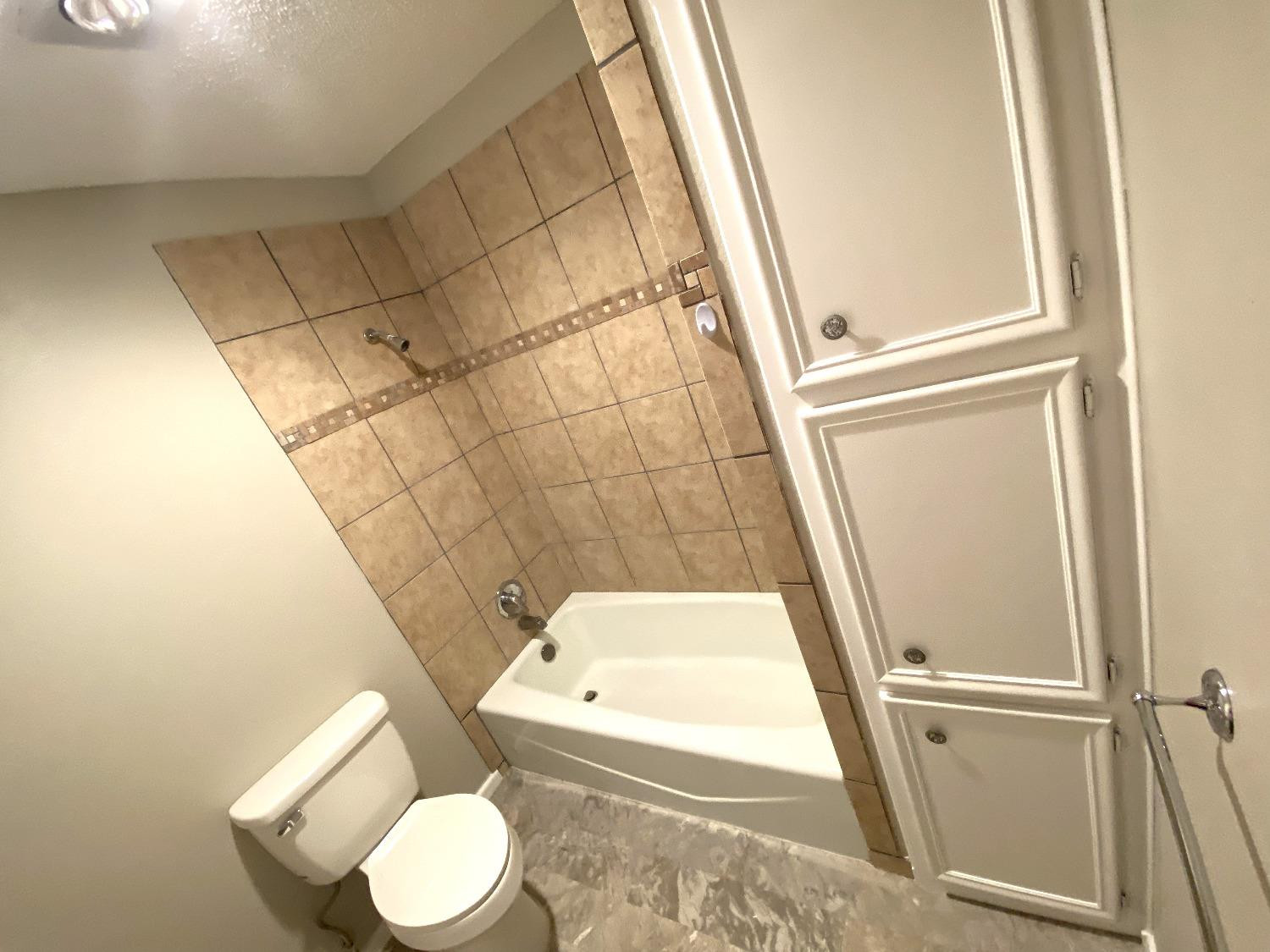9818 Jordan Avenue, Unit A Lubbock, TX 79423 - Photo 11 of 20 a bathroom with a sink and a toilet