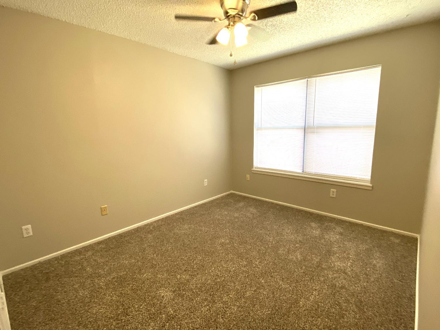 9818 Jordan Avenue, Unit A Lubbock, TX 79423 - Photo 12 of 20 an empty room with a window