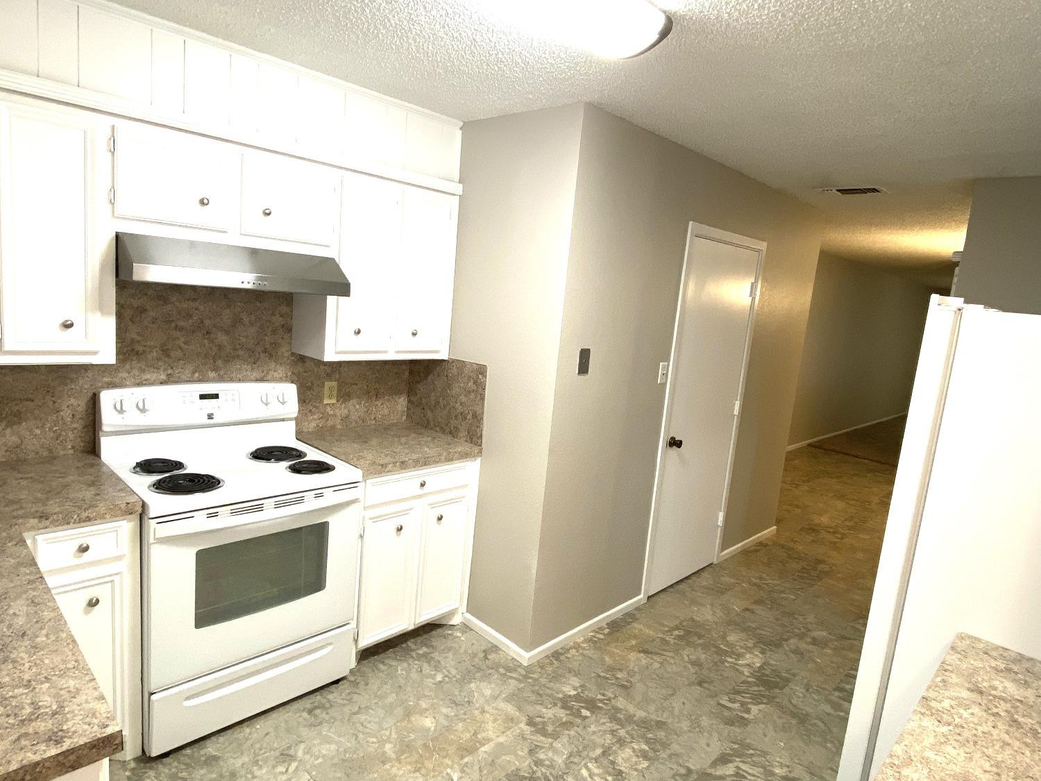 9818 Jordan Avenue, Unit A Lubbock, TX 79423 - Photo 4 of 20 a kitchen with a stove and a sink