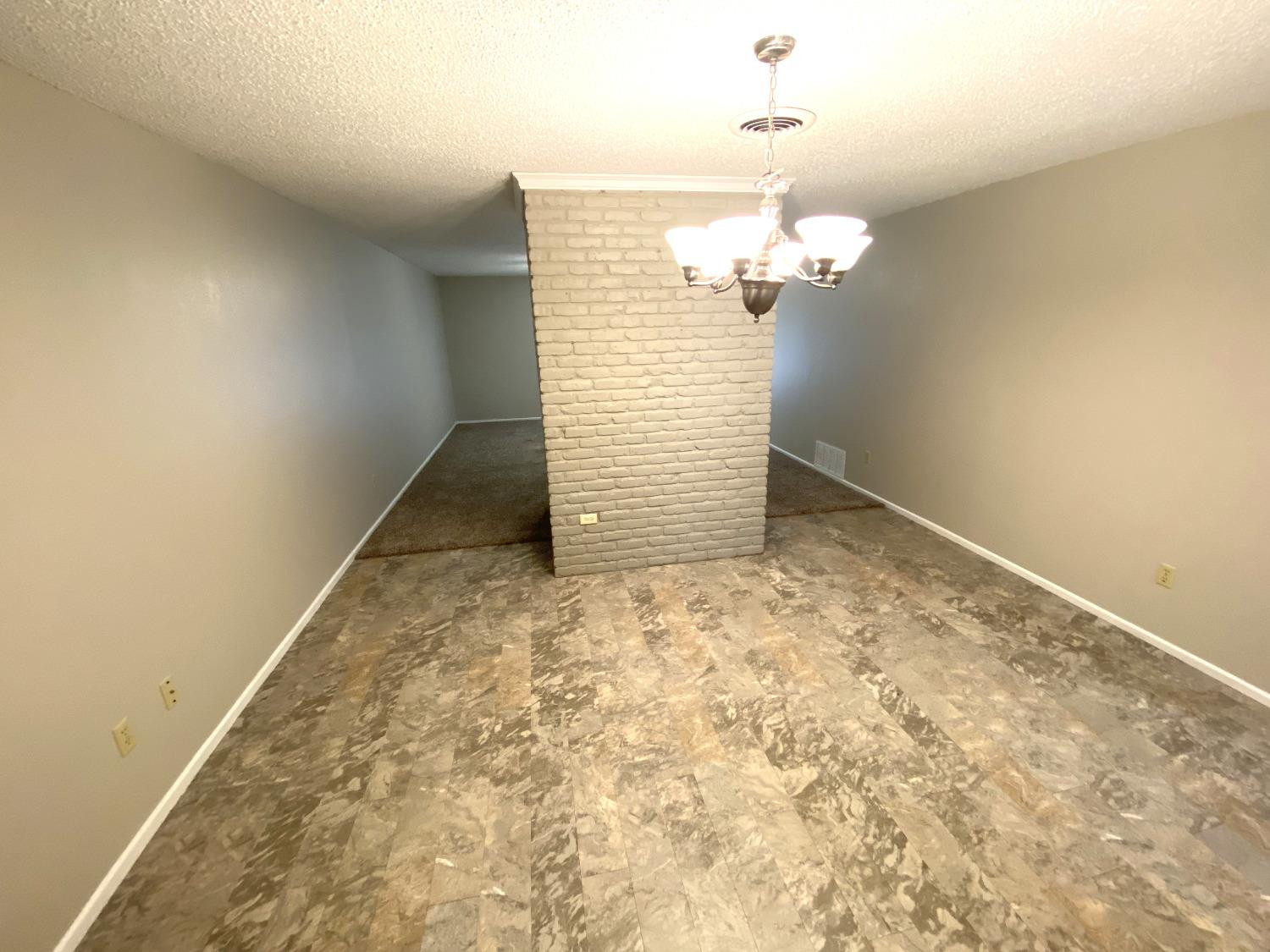 9818 Jordan Avenue, Unit A Lubbock, TX 79423 - Photo 7 of 20 a view of a chandelier fan in a room
