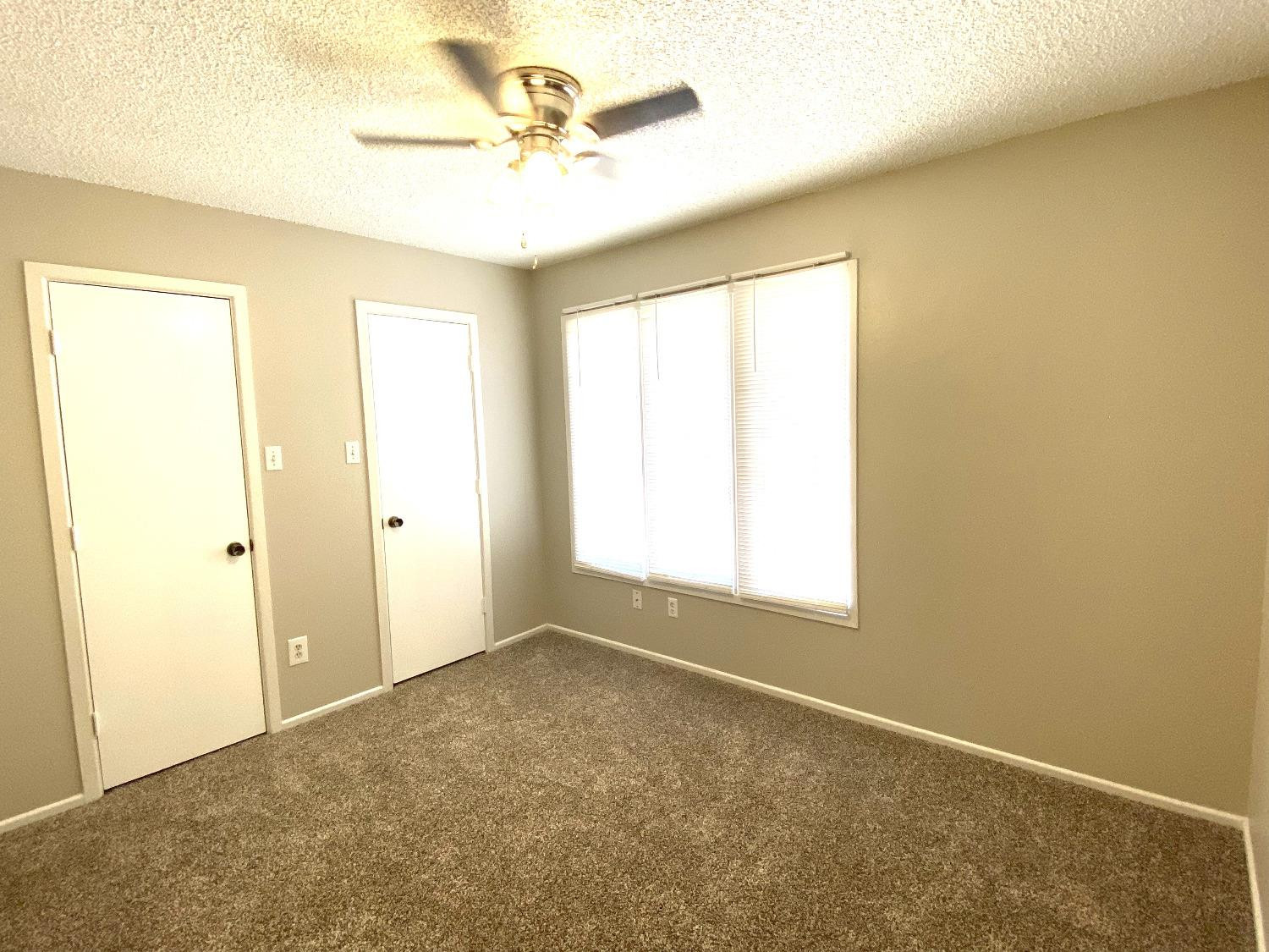 9818 Jordan Avenue, Unit A Lubbock, TX 79423 - Photo 8 of 20 a view of an empty room with a window