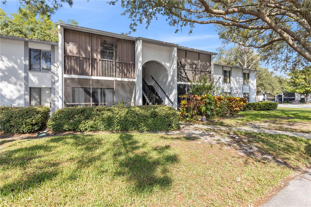 1258 Pine Ridge Circle West, Unit H2 Tarpon Springs, FL 34688 - Photo 1 of 1 a front view of a house with garden