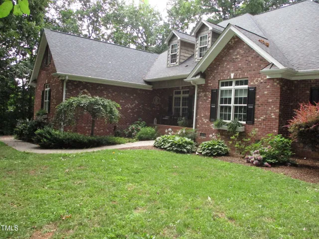 a view of a house with garden and yard