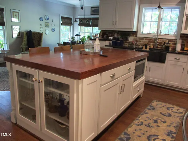 a kitchen with stainless steel appliances granite countertop a sink a stove and cabinets