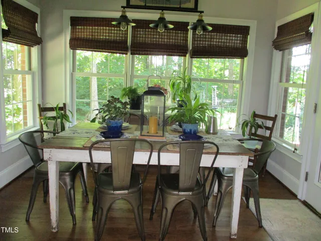 a view of a dining room with furniture and window