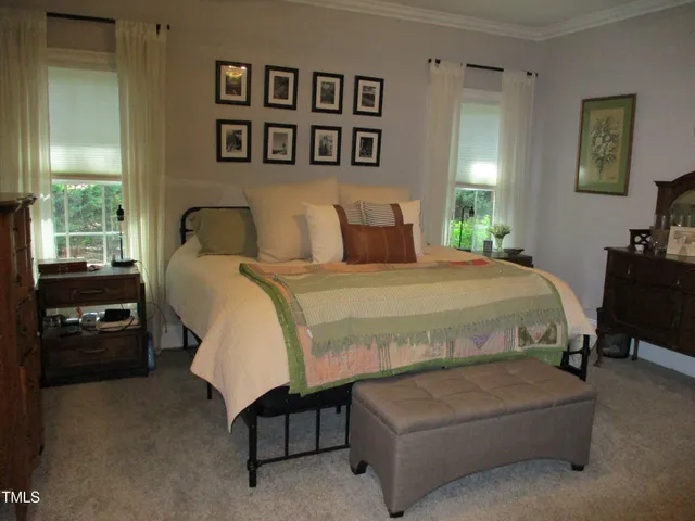 a bedroom with a bed and a view of bedroom