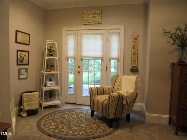 a living room with furniture a rug and a large window