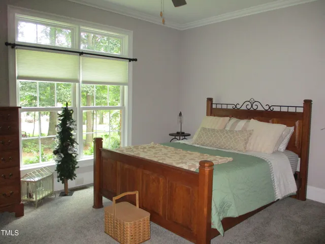 a bedroom with a bed and windows