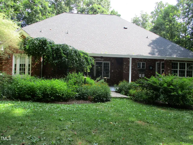 a aerial view of a house next to a yard