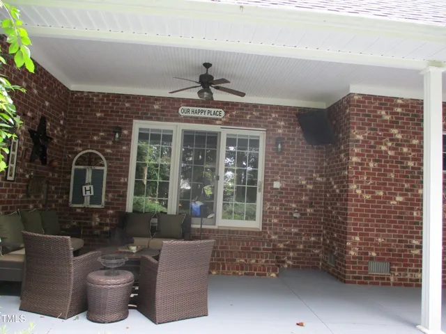 a front view of a house with outdoor seating