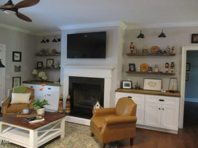 a living room with furniture fireplace and flat screen tv