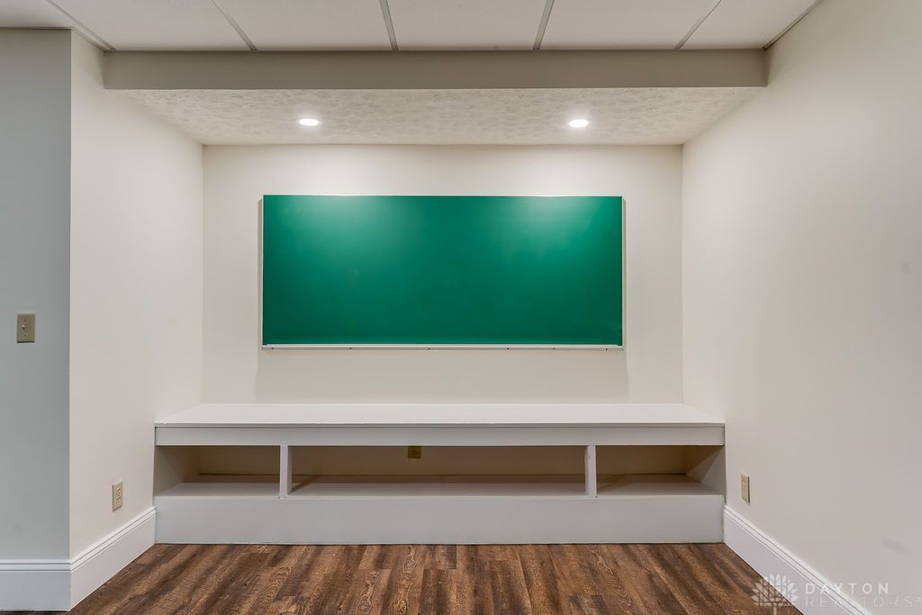 7400 Cook-Jones Road Waynesville, OH 45068 - Photo 55 of 72 This versatile recreation room features built-in shelving, rich flooring, and abundant lighting.