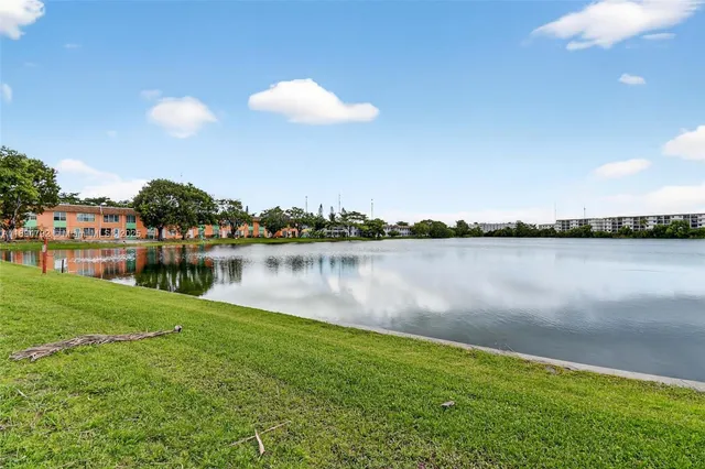 a view of a lake with houses in the back