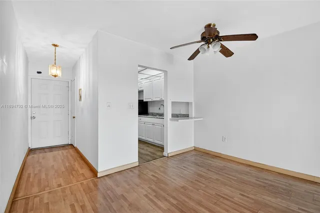 a view of a room with wooden floor and windows
