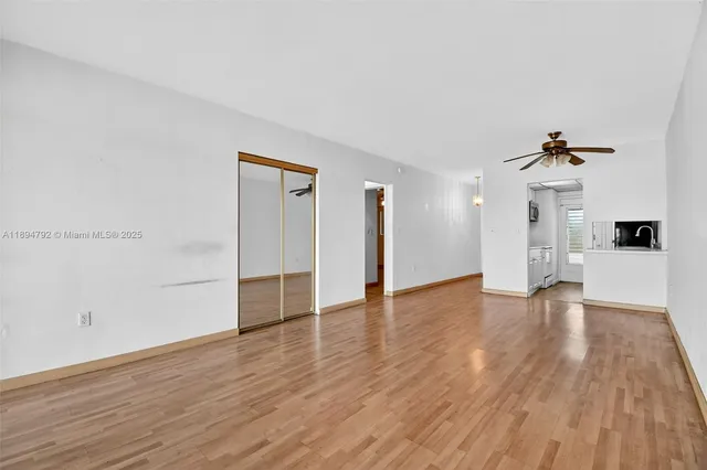 a view of a kitchen with wooden floor and a sink