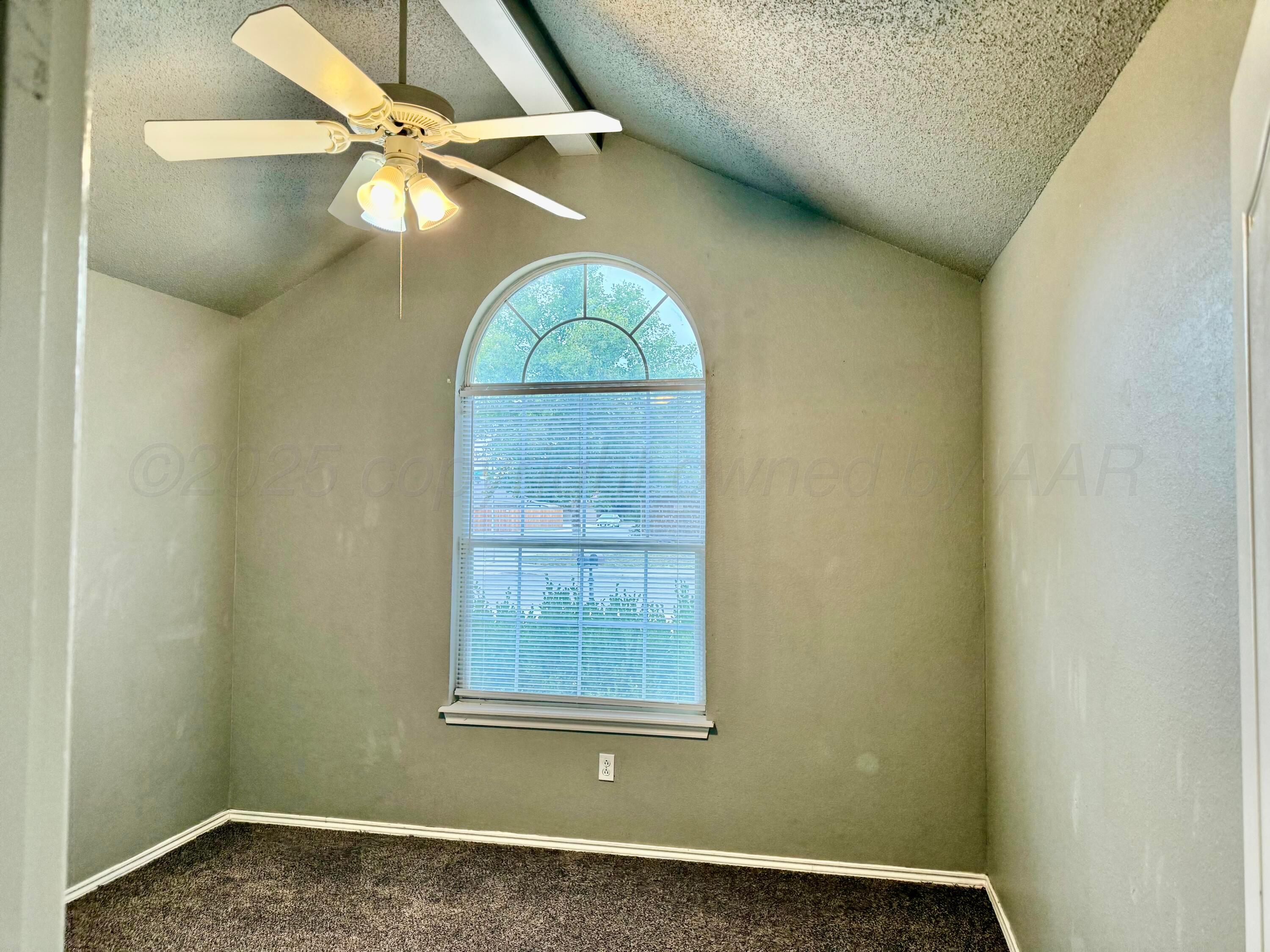 1918 75th Street Lubbock, TX 79423 - Photo 18 of 23 an empty room with windows and fan