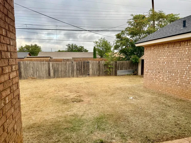 a view of a backyard of the house