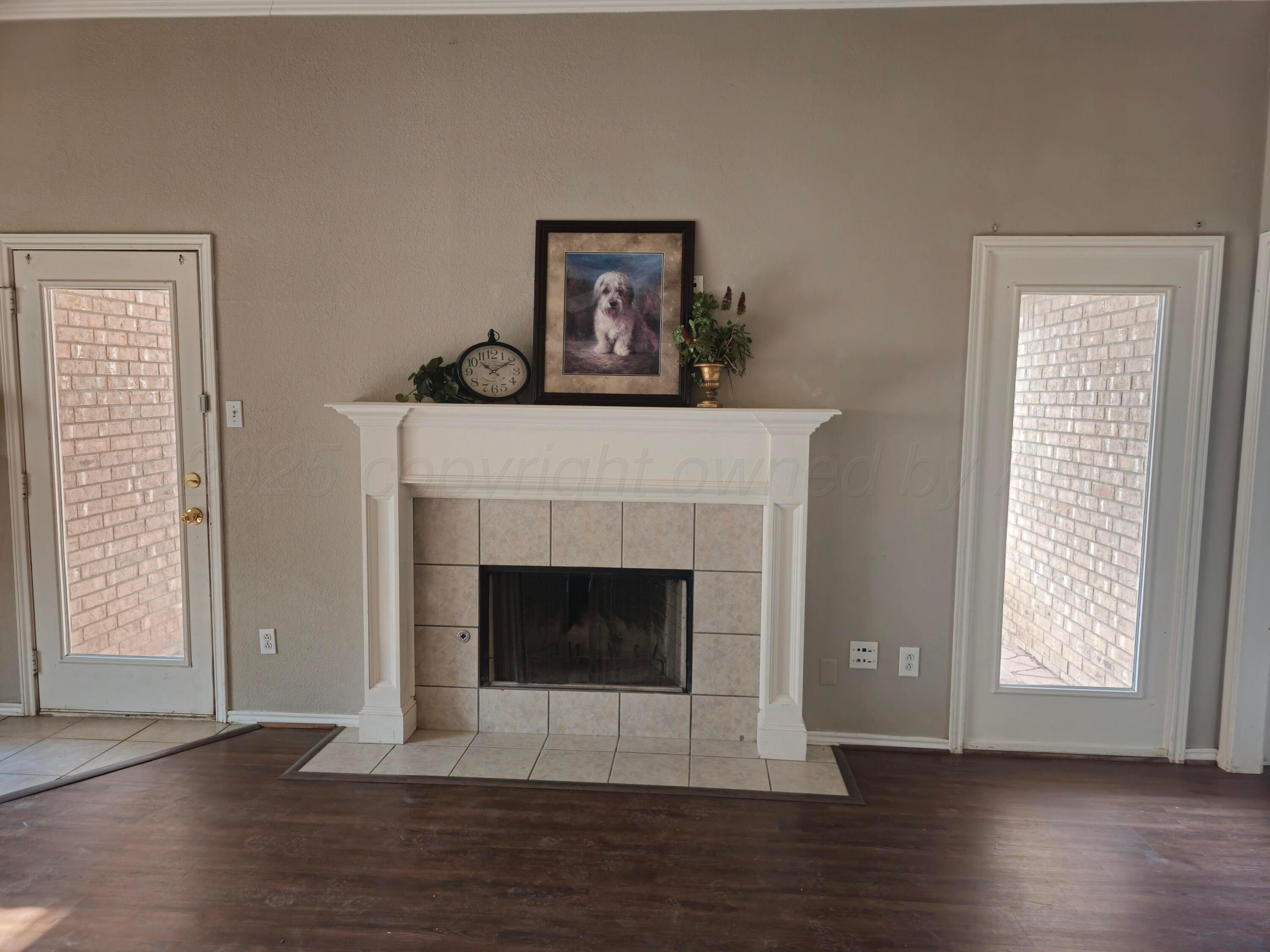 1918 75th Street Lubbock, TX 79423 - Photo 9 of 23 a living room with wooden floor and a fireplace