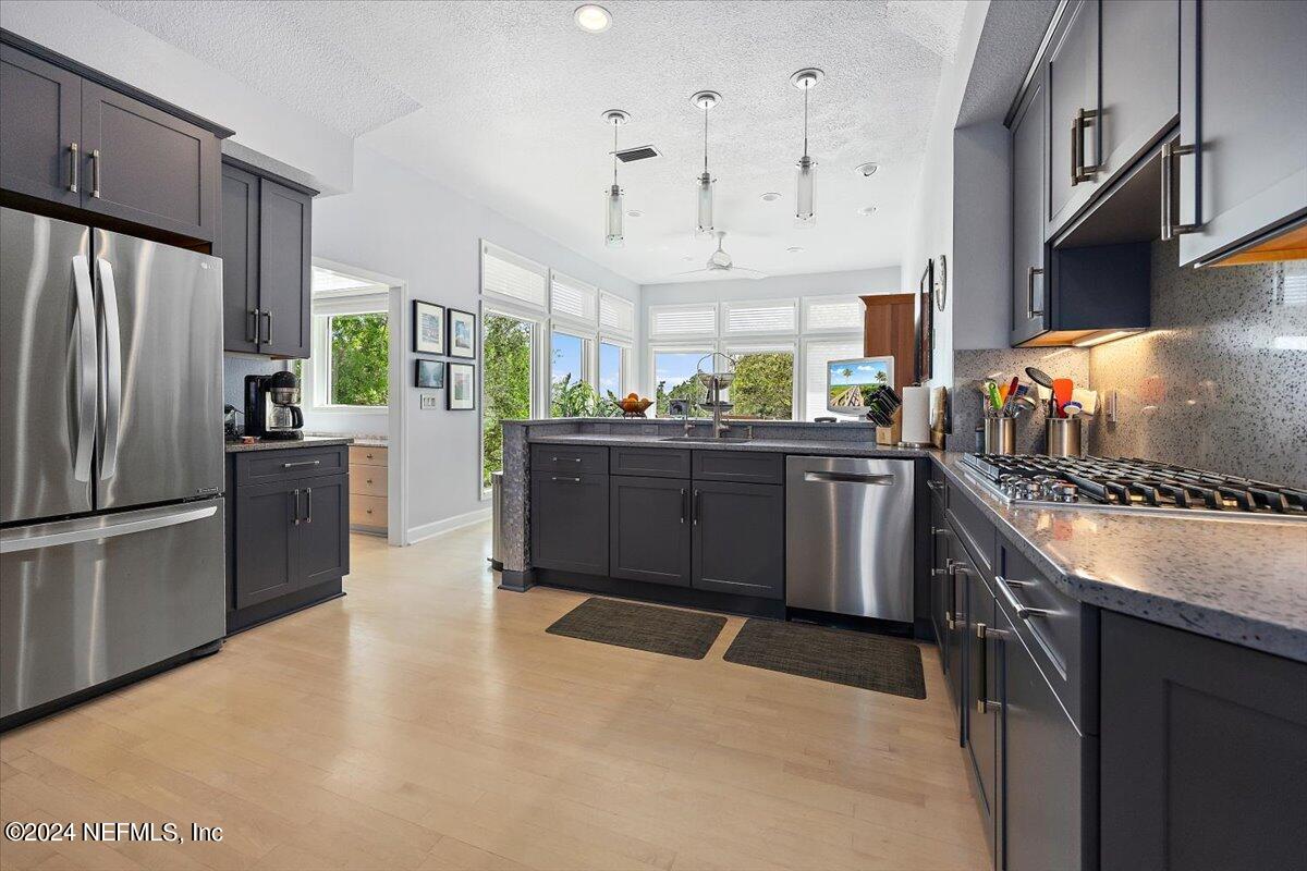 3419 Lands End Drive St. Augustine, FL 32084 - Photo 18 of 59 a kitchen with stainless steel appliances granite countertop a stove a sink a refrigerator and a refrigerator
