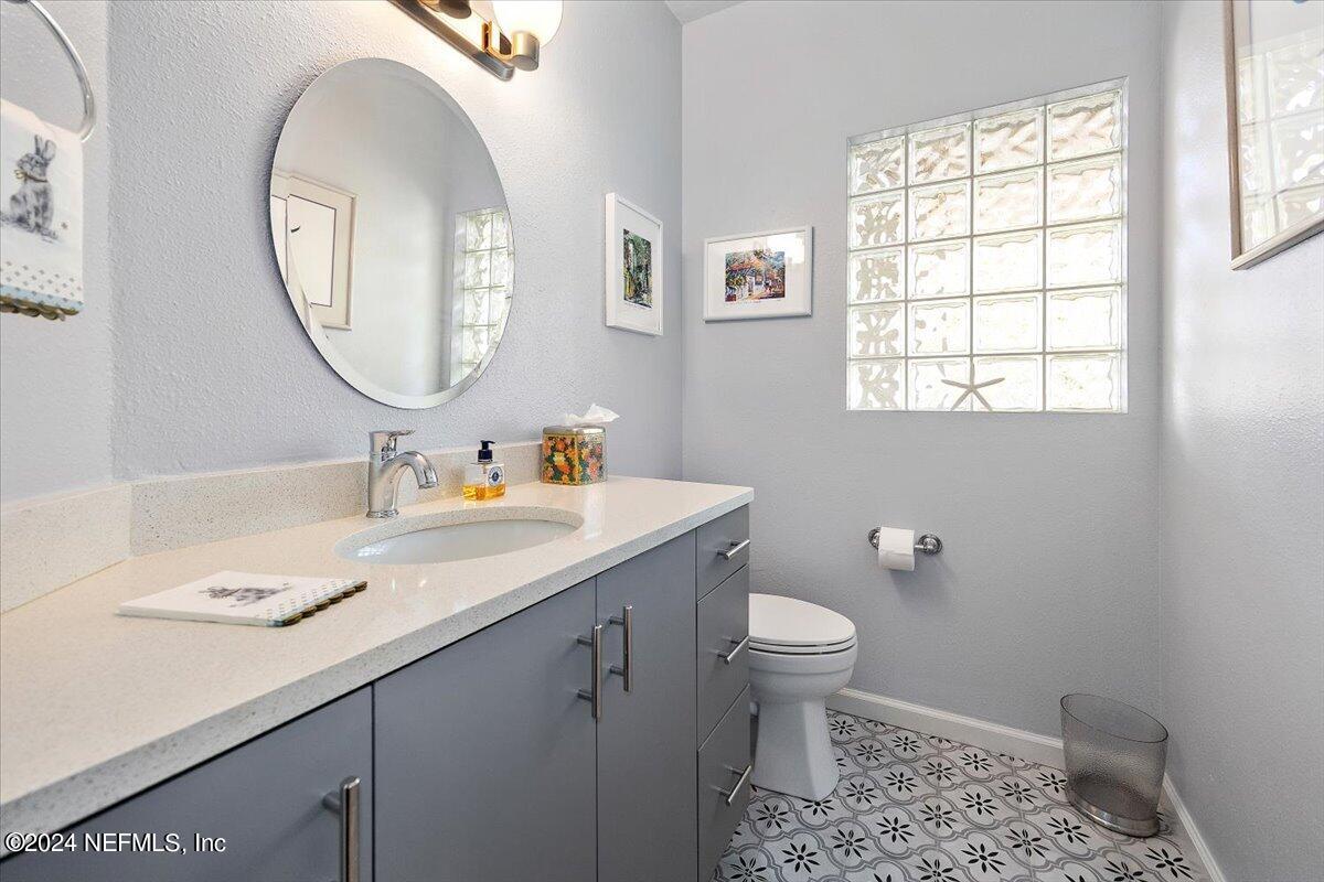 3419 Lands End Drive St. Augustine, FL 32084 - Photo 21 of 59 a bathroom with a granite countertop sink mirror and toilet