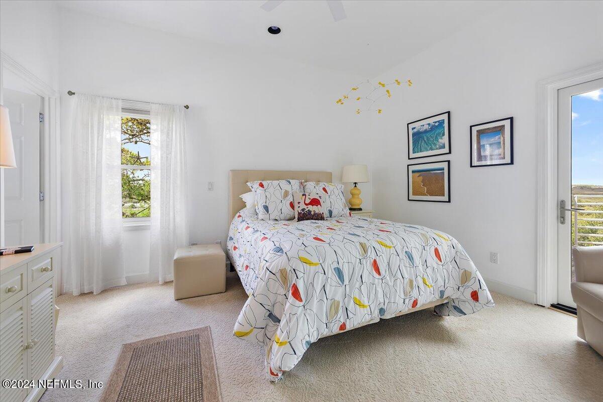 3419 Lands End Drive St. Augustine, FL 32084 - Photo 22 of 59 a bedroom with a bed next to a window