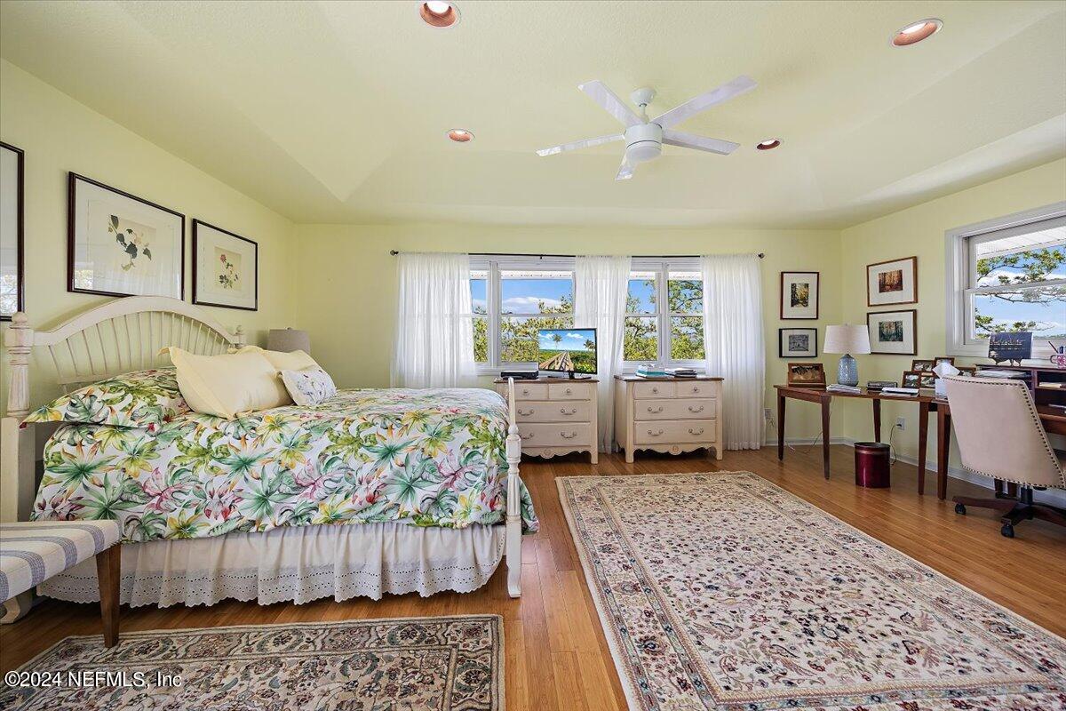 3419 Lands End Drive St. Augustine, FL 32084 - Photo 38 of 59 a bedroom with a bed and wooden floor