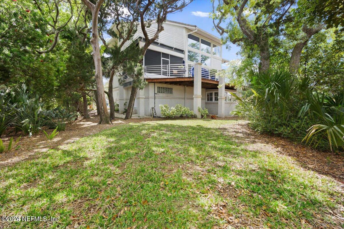 3419 Lands End Drive St. Augustine, FL 32084 - Photo 48 of 59 a view of a brick house with a big yard and large trees