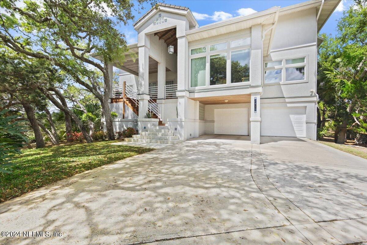3419 Lands End Drive St. Augustine, FL 32084 - Photo 50 of 59 a front view of a house with a yard and garage