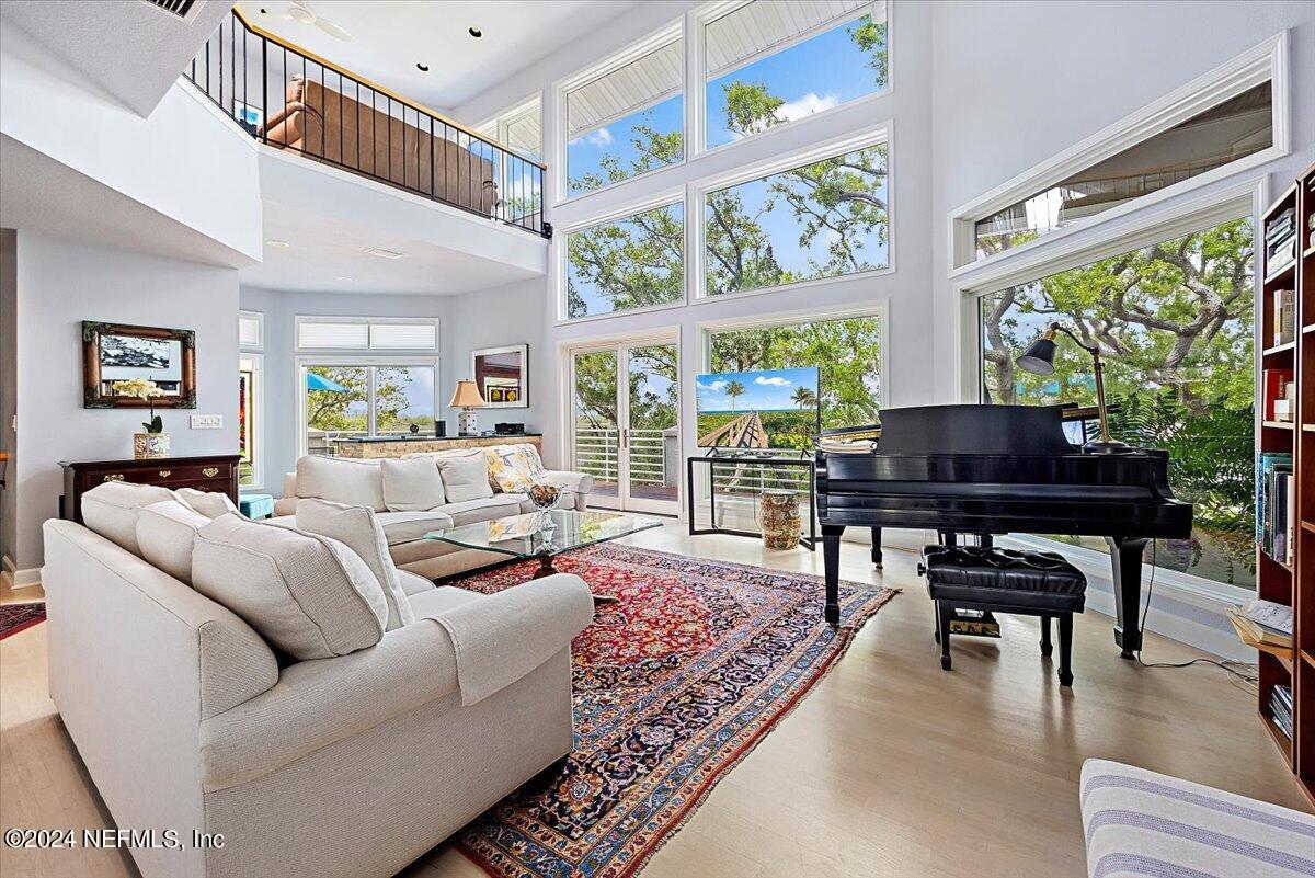 3419 Lands End Drive St. Augustine, FL 32084 - Photo 8 of 59 a living room with furniture a table and a large window