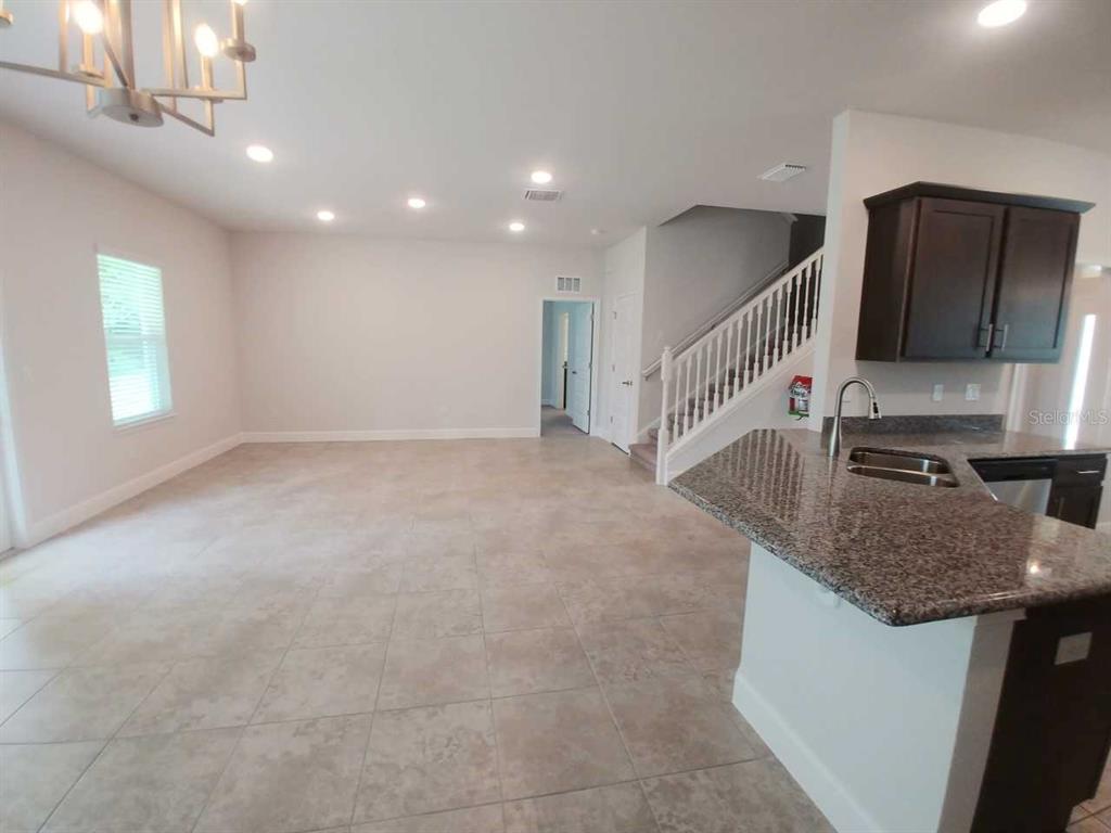 4380 Southwest 92nd Pl Road Ocala, FL 34476 - Photo 13 of 57 a kitchen that has a microwave a sink and a stove in it