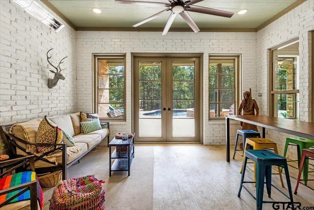 a living room with furniture and a floor to ceiling window