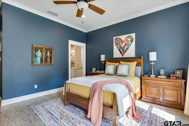 a bedroom with bed and ceiling fan