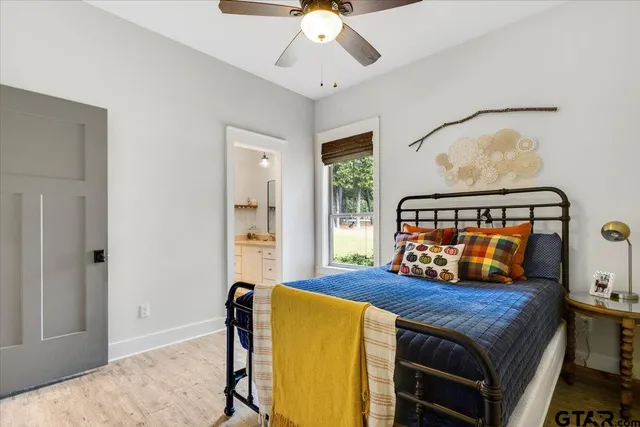 a bedroom with a bed and wooden floor