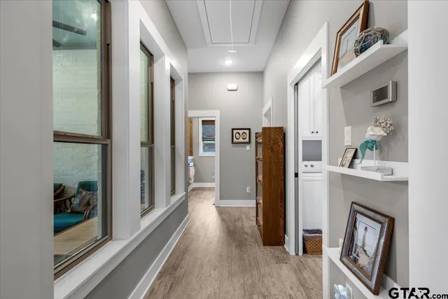 a view of hallway with wooden floor and staircase