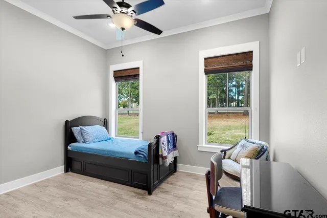a bedroom with furniture and a window