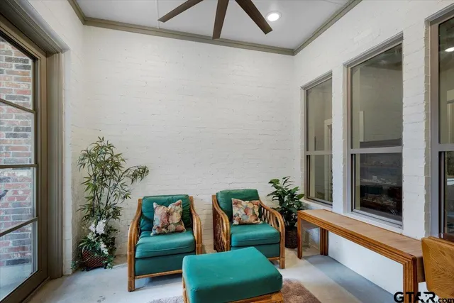 a living room with furniture and a potted plant