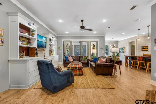 a living room with furniture and a book shelf