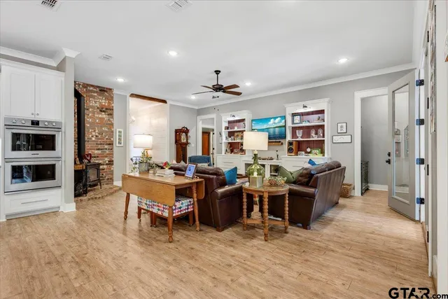 a living room with lots of furniture and a wooden floor