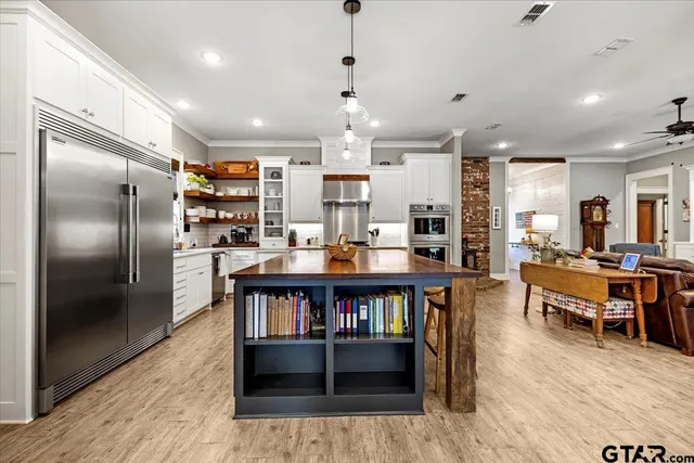 a large kitchen with a table and chairs