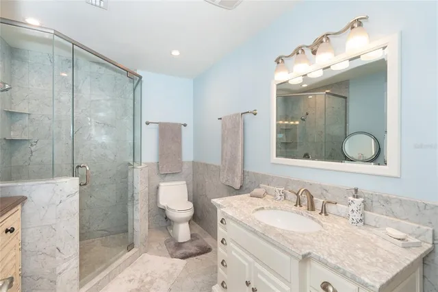 a bathroom with a shower a mirror and a sink