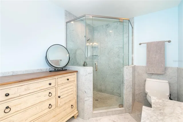 a bedroom with a bed and a flat tv screen on wall