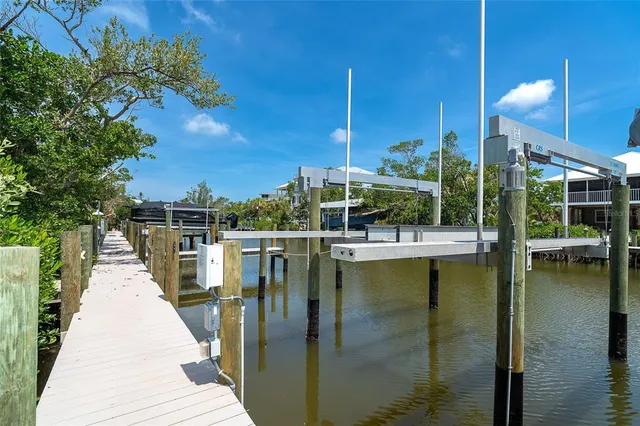 an aerial view of a house with a table chairs and lake view