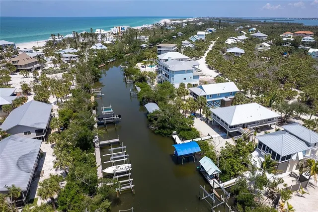 a view of a swimming pool with lawn chairs and couches