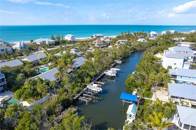 a view of a lake with lawn chairs