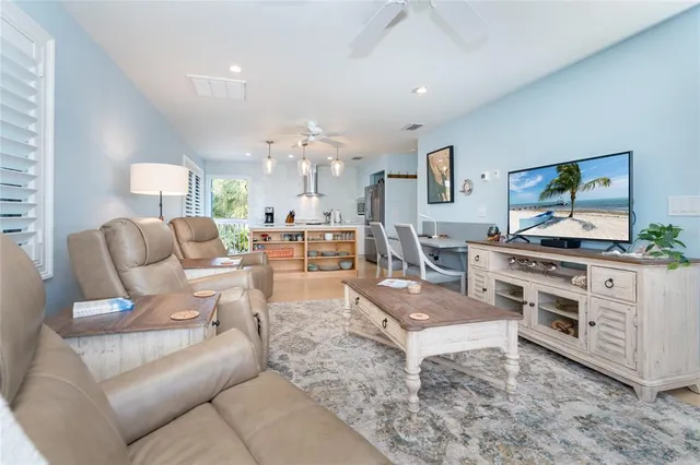 a view of a balcony with chairs and wooden floor