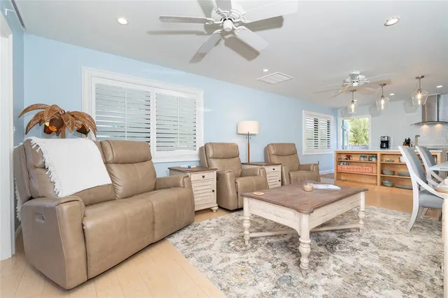 a large kitchen with stainless steel appliances granite countertop a sink a stove and a refrigerator