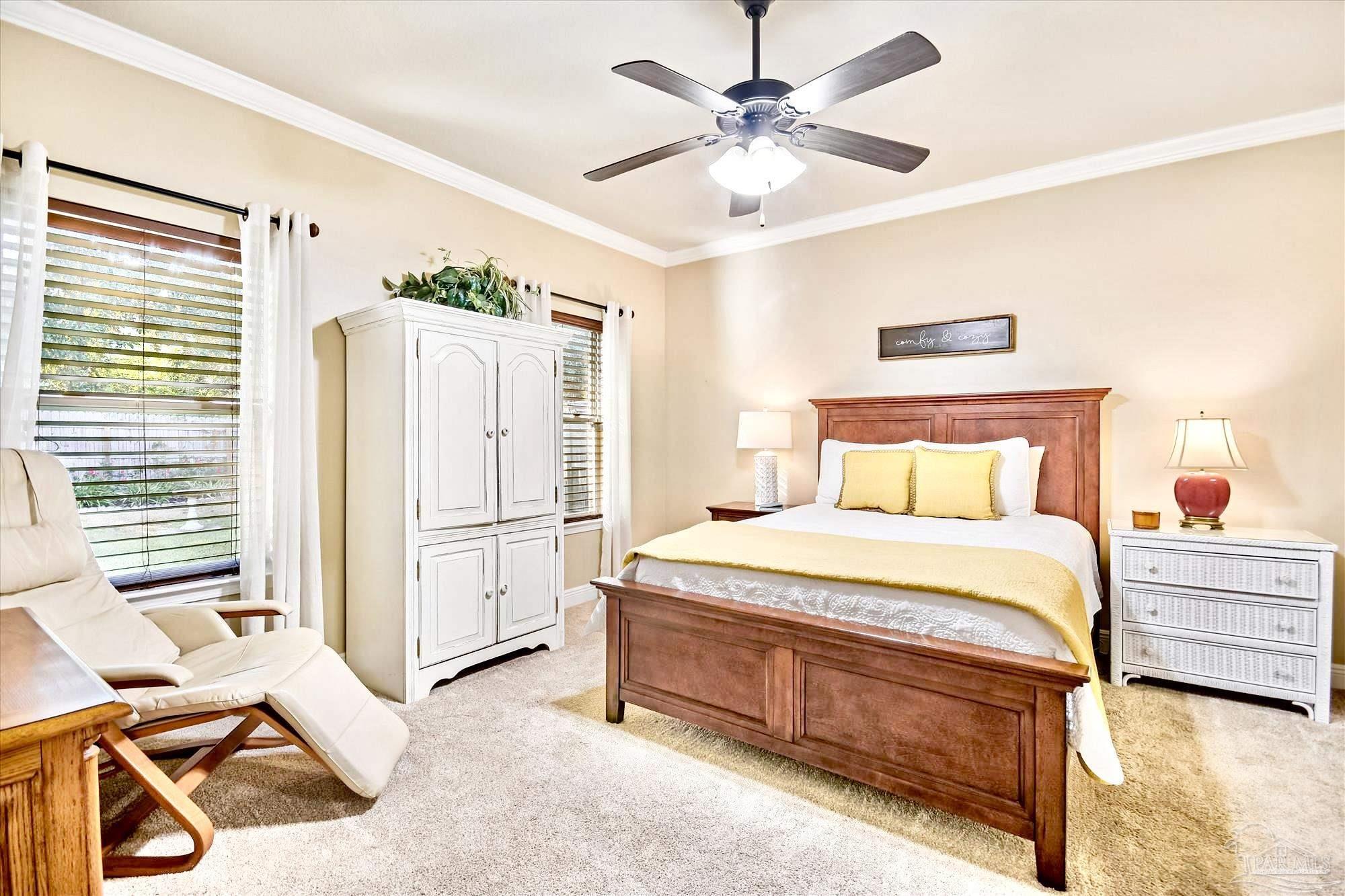 745 Farmington Road Pensacola, FL 32504 - Photo 13 of 25 a spacious bedroom with a bed and a chandelier