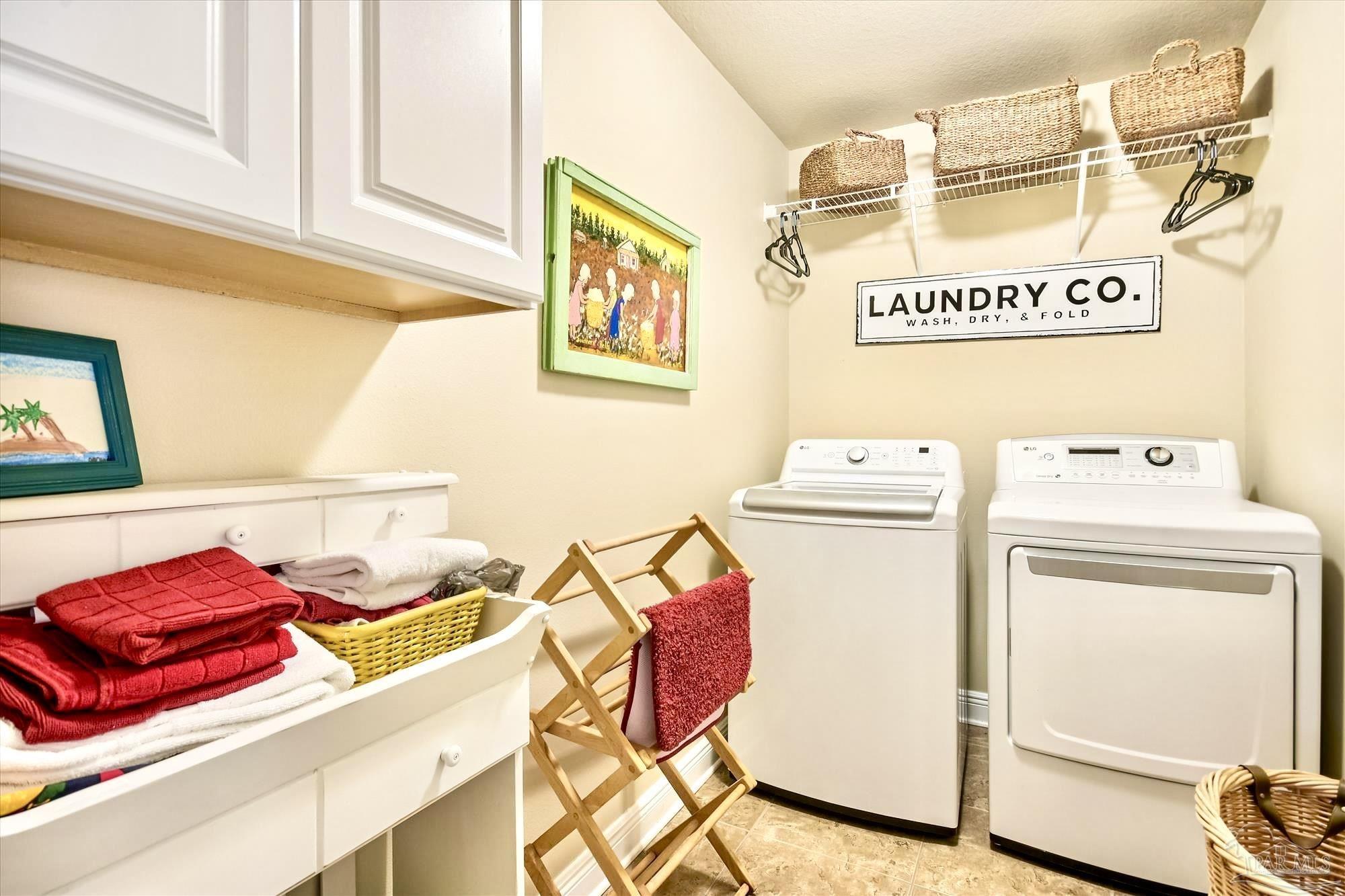 745 Farmington Road Pensacola, FL 32504 - Photo 22 of 25 a utility room with a refrigerator and washer