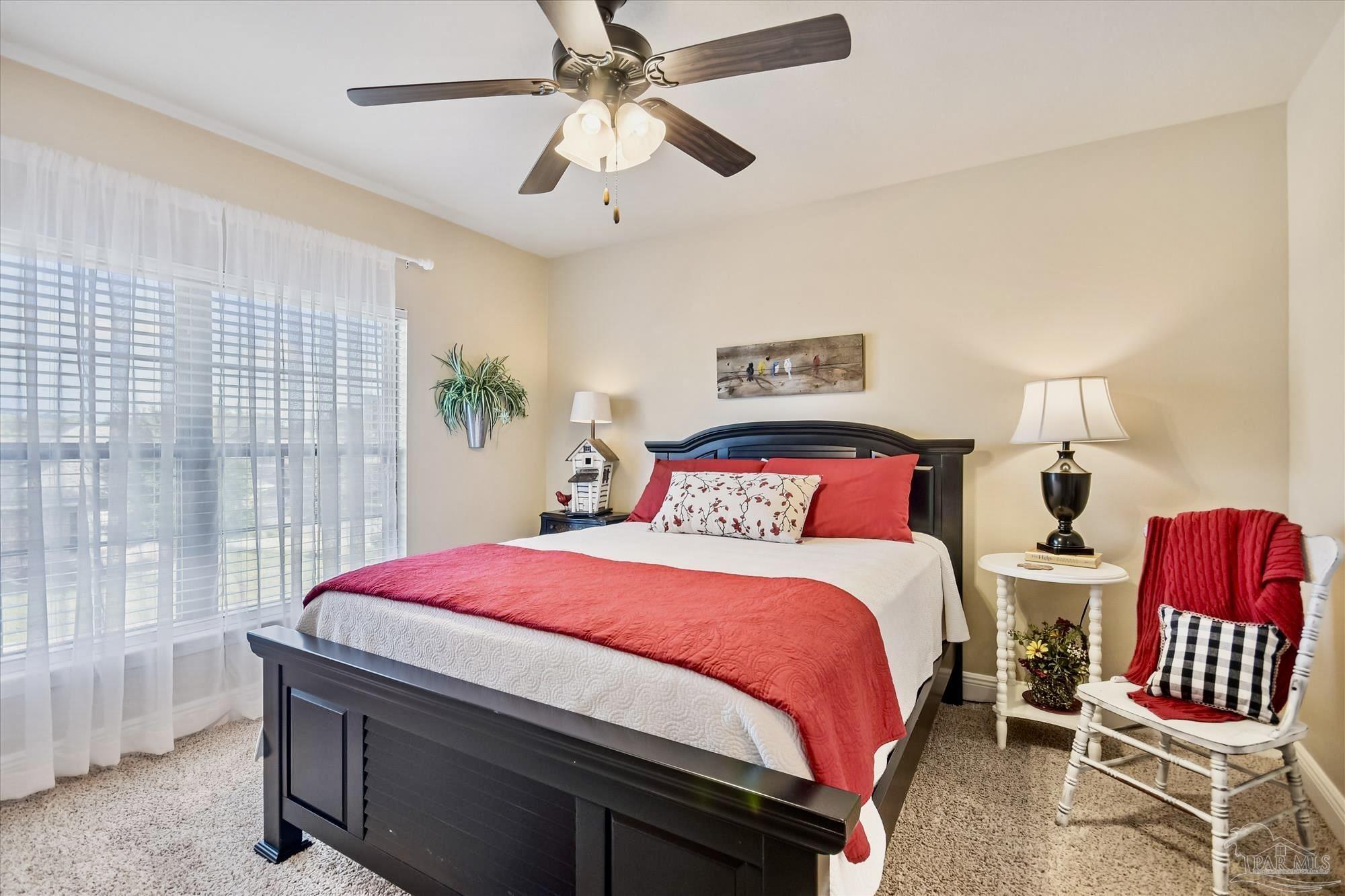 745 Farmington Road Pensacola, FL 32504 - Photo 23 of 25 a bedroom with a bed a chandelier and dresser