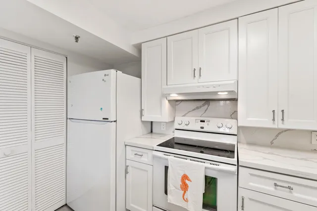a kitchen with a white cabinets and white appliances